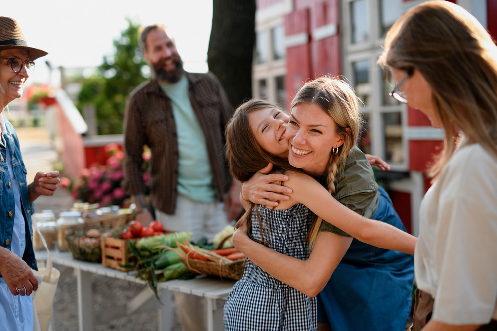 little-girl-with-mother-hugging-outdoors-at-commun-2022-01-18-23-50-56-utc.jpg